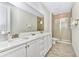Double vanity bathroom with a quartz countertop and shower at 8103 Coconut Place, Kissimmee, FL 34747