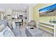 Living room with gray sofa, ottoman, and a large TV at 8103 Coconut Place, Kissimmee, FL 34747