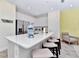 Kitchen island with white cabinets, quartz countertops, and stainless steel appliances at 8103 Coconut Place, Kissimmee, FL 34747
