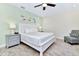 King bedroom with a ceiling fan and coastal-themed artwork at 8103 Coconut Place, Kissimmee, FL 34747