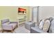Living room with gray sofa, ottoman, and a large TV at 8103 Coconut Place, Kissimmee, FL 34747
