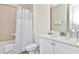 Bathroom with white vanity, tub, and shower at 8103 Coconut Place, Kissimmee, FL 34747