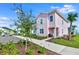 View of pastel townhome with landscaping at 8103 Coconut Place, Kissimmee, FL 34747