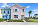 Pastel-colored townhome with landscaping and sidewalk at 8103 Coconut Place, Kissimmee, FL 34747