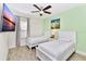Two twin beds in a bright bedroom with light walls and art at 8103 Coconut Place, Kissimmee, FL 34747