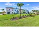 Row of colorful townhouses with lush landscaping and palm trees at 8103 Coconut Place, Kissimmee, FL 34747