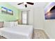 King-size bed in a bedroom with light walls and beach art at 8103 Coconut Place, Kissimmee, FL 34747