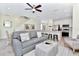 Living room with gray sofa, ottoman, and a large TV at 8103 Coconut Place, Kissimmee, FL 34747