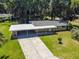 Aerial view showcasing a ranch house and driveway at 1009 Loves Point Dr, Leesburg, FL 34748