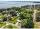 Aerial view of property near lake and lush vegetation at 1009 Loves Point Dr, Leesburg, FL 34748