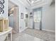 Bright and airy entryway with tiled floor, decorative rug, and access to other rooms at 4904 W Fountainwood Dr, St Cloud, FL 34772