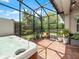 Hot tub in screened enclosure with lush landscaping at 4904 W Fountainwood Dr, St Cloud, FL 34772
