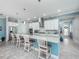Modern kitchen with white cabinets, granite counters, and island seating at 4904 W Fountainwood Dr, St Cloud, FL 34772
