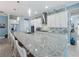 Modern kitchen with white cabinets, granite island, and stainless steel appliances at 4904 W Fountainwood Dr, St Cloud, FL 34772