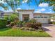 Two-story home with attractive landscaping, two-car garage, and brick driveway at 4904 W Fountainwood Dr, St Cloud, FL 34772