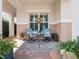 Inviting front porch with comfortable seating, potted plants and decorative rug at 4904 W Fountainwood Dr, St Cloud, FL 34772