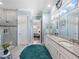 Bright bathroom with double vanity, walk-in shower, and bedroom view at 4904 W Fountainwood Dr, St Cloud, FL 34772