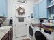 Laundry room with washer, dryer, and built-in cabinets at 4904 W Fountainwood Dr, St Cloud, FL 34772