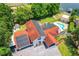 Aerial view of house, pool, and large lot with solar panels at 5117 Turkey Lake Rd, Orlando, FL 32819