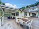 Deck with dining area and seating area, overlooking the pool at 5117 Turkey Lake Rd, Orlando, FL 32819