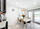 Bright kitchen nook with white table and chairs, offering view to backyard at 5117 Turkey Lake Rd, Orlando, FL 32819