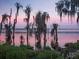 Scenic sunset view over a lake with trees at 11027 Cromwell Rd, Orlando, FL 32827