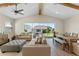 Living room with sliding glass doors, neutral-toned furniture, and wood-look flooring at 745 Curly Locks Loop, Apopka, FL 32703