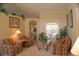 Bright living room featuring comfortable seating and a view into the dining area at 3327 Shrike Hill Court, Clermont, FL 34714