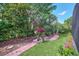 Landscaped backyard with a brick pathway at 11514 Via Lucerna Cir, Windermere, FL 34786