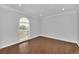 Bright bedroom with hardwood floors and arched window at 11514 Via Lucerna Cir, Windermere, FL 34786