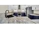 Modern kitchen with granite countertops and dark blue cabinetry at 11514 Via Lucerna Cir, Windermere, FL 34786