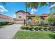 Two-story house with tan exterior, tile roof, and a three-car garage at 11514 Via Lucerna Cir, Windermere, FL 34786