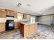 Open concept kitchen with island, granite countertops, and dark wood cabinets at 40407 Sunset Dr, Eustis, FL 32736