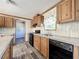 Kitchen with wood cabinets, granite counters and black appliances at 40407 Sunset Dr, Eustis, FL 32736