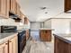 Open concept kitchen with island, granite countertops and dark wood cabinets at 40407 Sunset Dr, Eustis, FL 32736
