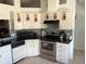 Kitchen with dark wood cabinets, granite counters and stainless steel appliances at 3723 Imperial Dr, Winter Haven, FL 33880