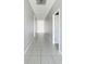 Hallway with tile flooring and white doors at 274 Tarpon Bay Blvd, Haines City, FL 33844