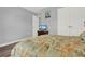 Bedroom with leafy bedding, wood-look floors, and a dresser at 4223 Arlington Ridge Blvd, Leesburg, FL 34748