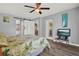 Bright bedroom with a leafy patterned bedspread, ceiling fan, and barn door at 4223 Arlington Ridge Blvd, Leesburg, FL 34748