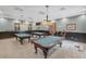 Community billiards room with multiple tables for recreation at 4223 Arlington Ridge Blvd, Leesburg, FL 34748