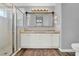 Bathroom with double sinks, a large mirror and a walk-in shower at 4223 Arlington Ridge Blvd, Leesburg, FL 34748