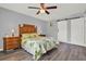 Bedroom with wood-toned furniture and a tropical-themed bedspread at 4223 Arlington Ridge Blvd, Leesburg, FL 34748