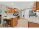 Kitchen with island, stainless steel appliances, and light wood cabinets at 4223 Arlington Ridge Blvd, Leesburg, FL 34748