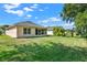 Landscaped backyard with grassy area at 4223 Arlington Ridge Blvd, Leesburg, FL 34748