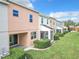 Rear view of colorful townhouses with patios and landscaping at 734 Marotta Loop, Ocoee, FL 34761