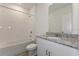 Clean bathroom with granite countertop, white cabinets, and bathtub at 1167 Foreshore Ln, Haines City, FL 33844