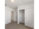Bright bedroom with carpet flooring, double door closet, and access to another room at 1167 Foreshore Ln, Haines City, FL 33844