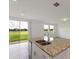 Modern kitchen island with granite countertop and stainless steel dishwasher at 1167 Foreshore Ln, Haines City, FL 33844