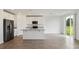 Open concept kitchen with white cabinets and granite countertops at 1167 Foreshore Ln, Haines City, FL 33844