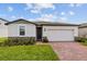 One-story house with two-car garage and brick driveway at 1167 Foreshore Ln, Haines City, FL 33844